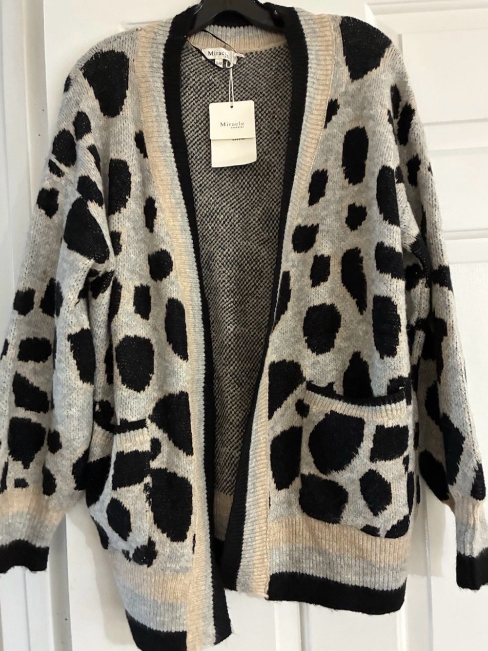 Miracle brand NWT S/M cardigan features a grey and black leopard print design